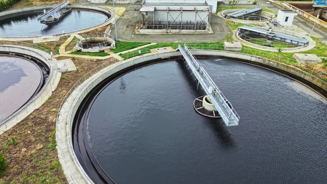 Plant includes systems. Facility has various modules. Water processing setup with multiple components. Industrial sewage treatment employing distinct circular and aeration units