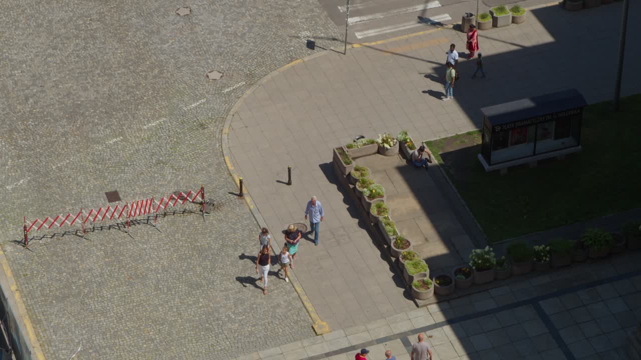 A view from the Palace of Culture and Science in Warsaw of people walking in the square in front of the Palace