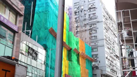 building under construction with scaffolding and netting