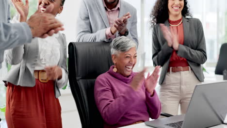 excited woman in office with laptop