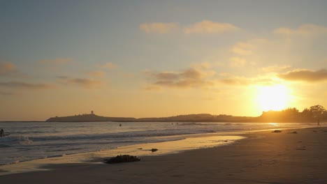 Pillar-Point-from-El-Granada,-California-and-Cloudy-Sky-with-a-Beatiful-Sunset-and-Surfers-Riding-the-Waves