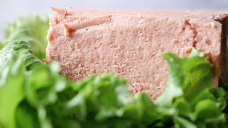 close-up of liverwurst on a bed of lettuce