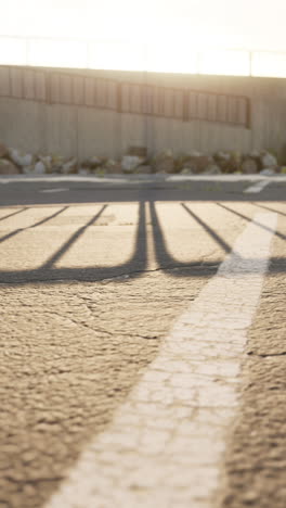 shadow of a fence in a parking lot