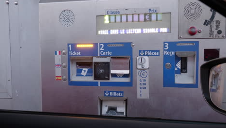 paying toll fees at a french toll booth