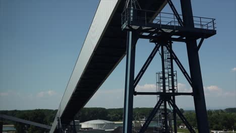 Downward-tripod-shot-on-a-conveyor-belt-at-a-coal-power-plant-in-Europe