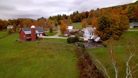 slow aerial push to vermont farm scene in fall