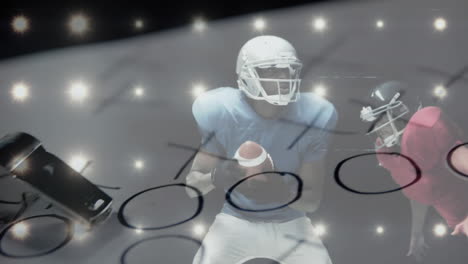 african american football player catches ball against caucasian opponent, coach's tools in front.