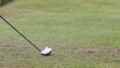 golf club striking ball in a fluid motion