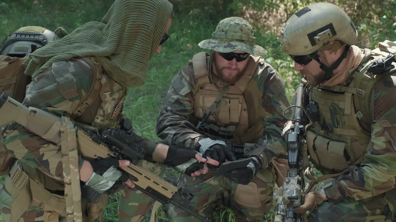 Military Men With Digital Tablet In Jungle