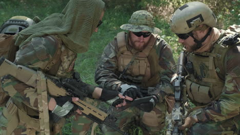 military men with digital tablet in jungle