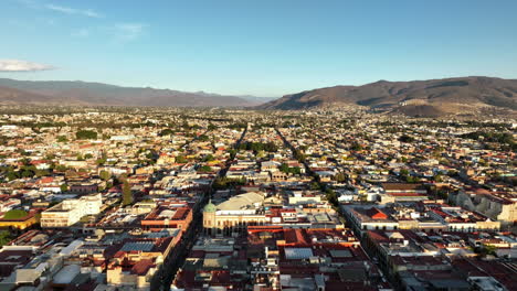 Aerial-View-of-Oaxaca-Cathedral-and-Cityscape-at-Sunset,-Mexico,-Colonial-Landmark-and-Homes