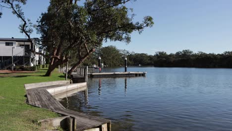 Walkway-leading-to-pier-at-Moona-Moona-Creek-shore-on-Lions-park,-Locked-shot