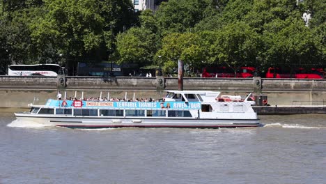 tourist boat moving along the river thames