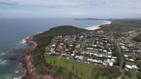 view from above of grant's head in bonny hills, camden haven, nsw, australia. aerial ascending shot