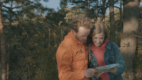 young female and male hikers looking at a map 1