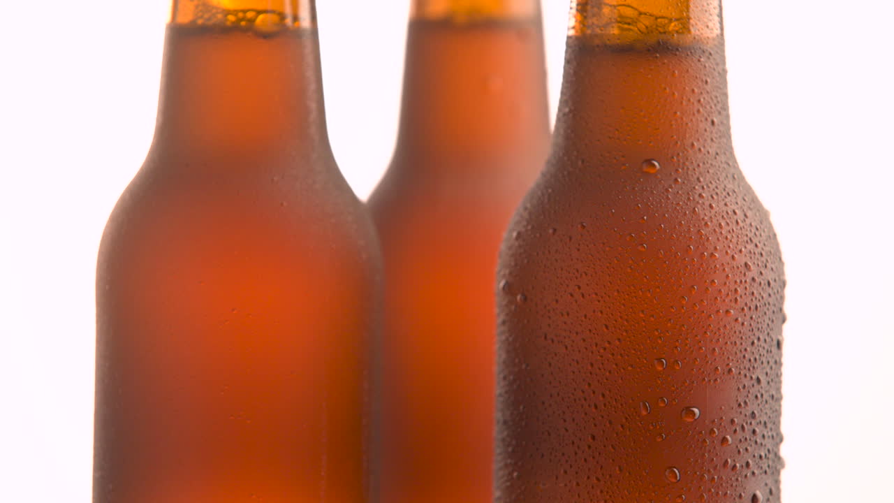 Two beer bottle rotating on white background