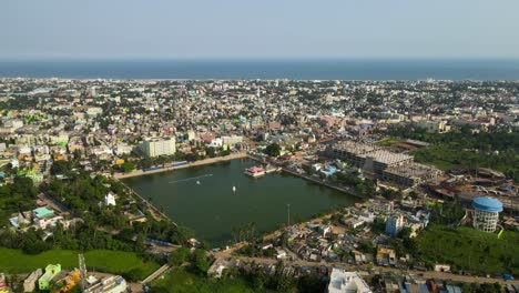 aerial drone shot of jagannath puri city, with the iconic temple standing tall against the backdrop of a serene sky.