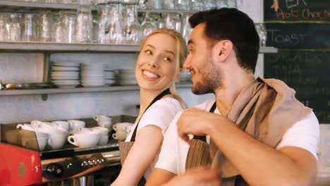 Waiter-and-waitress-interacting-while-working