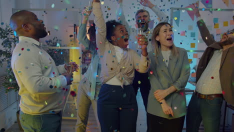 office celebration with confetti and dancing