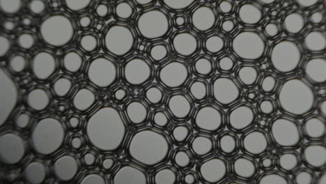 interacción atómica de las partículas. visualización abstracta de las partículas a nivel atómico. células, estructura, fuerzas de interacciones interatómicas. enfoque suave bajo la lente del microscopio