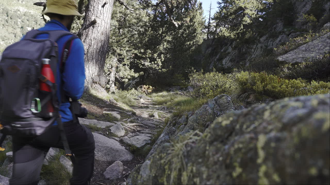 couple of trekker climber walking a stone path in Aig&uuml;estortes National Park Catalan Pyrenees
