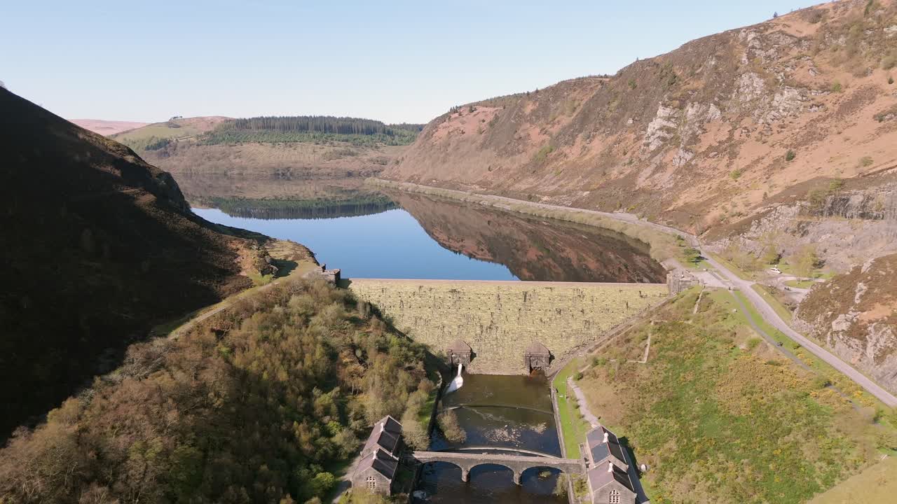 An aerial view of Caban Coch dam and reservoir on a sunny spring day in the Elan valley, Powys, Wales