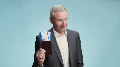 man holding passport and airplane tickets
