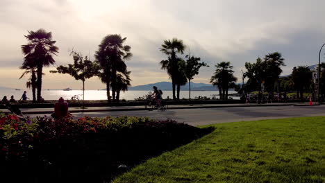 sunset at english bay while new restrictions pilans for vehicle traffic exculded on roadway as physical social distancing bike lanes at beachside headed to stanley park tripod hold