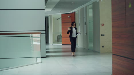 businesswoman walking in office corridor