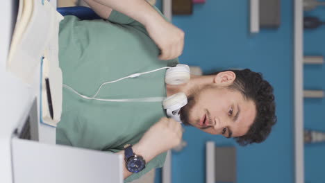 Vertical-video-of-A-male-student-who-is-overwhelmed-by-the-heat.