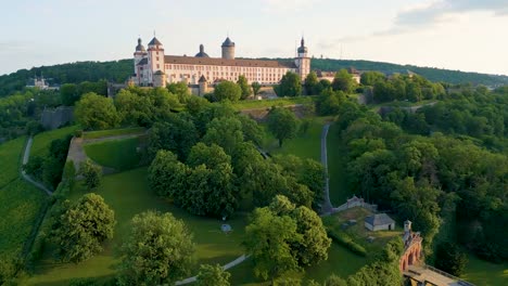 4k aerial drone video of the marienberg fortress and fürstengarten garden in würzburg, germany