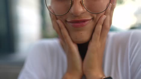 woman smiling with hands on her face