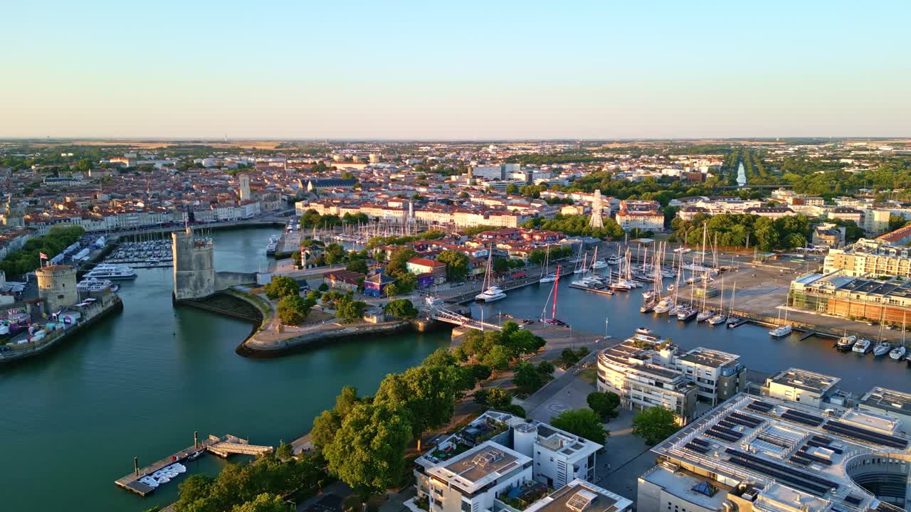 Golden hour drone view of La Rochelle harbor with medieval Chain Tower and sailboats, Charente-Maritime, France