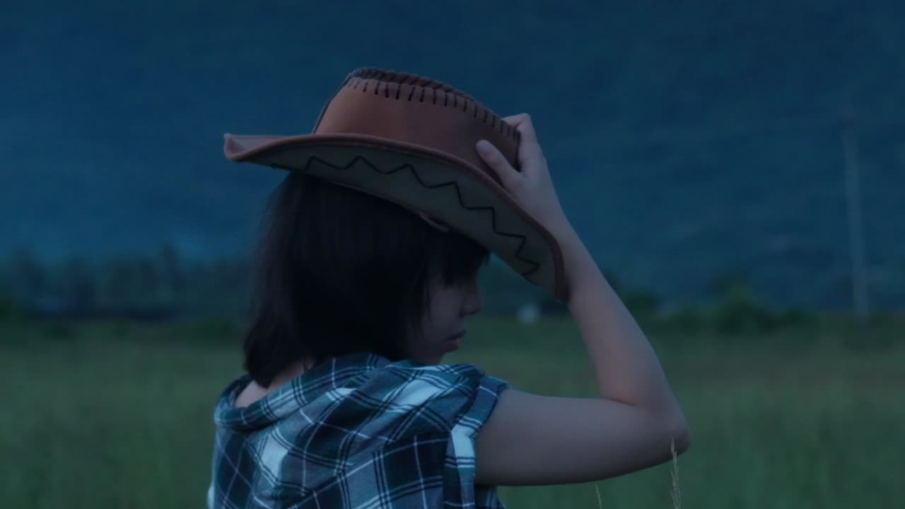 Portrait Of A Countryside Cowgirl Wearing A Brown Hat. Slow Motion Shot
