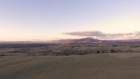 drone pans over homes with beautiful mountain in the distance