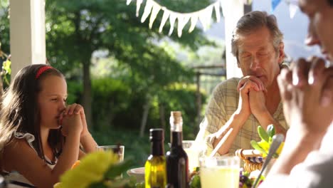 family eating outside together in summer