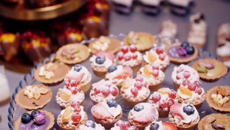 fruit cream tarts and pastries on dessert plate, push out