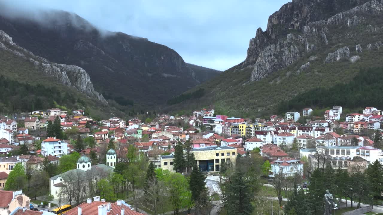 Drone shot of a small village next to a mountain