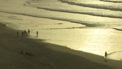 beach scene at sunset with people