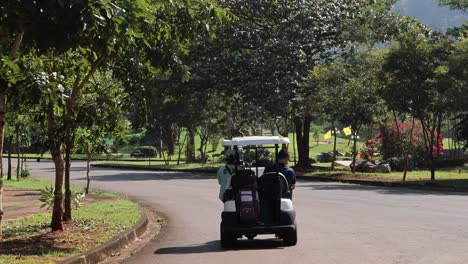 golf cart driving along a scenic park road