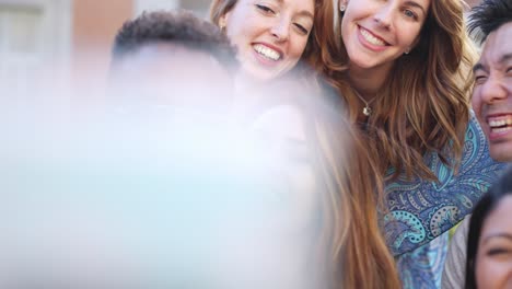 diverse group of friends taking funny selfies