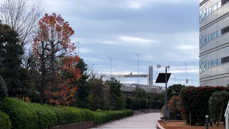 a peaceful tokyo cityscape featuring autumn trees and modern architecture outdoors