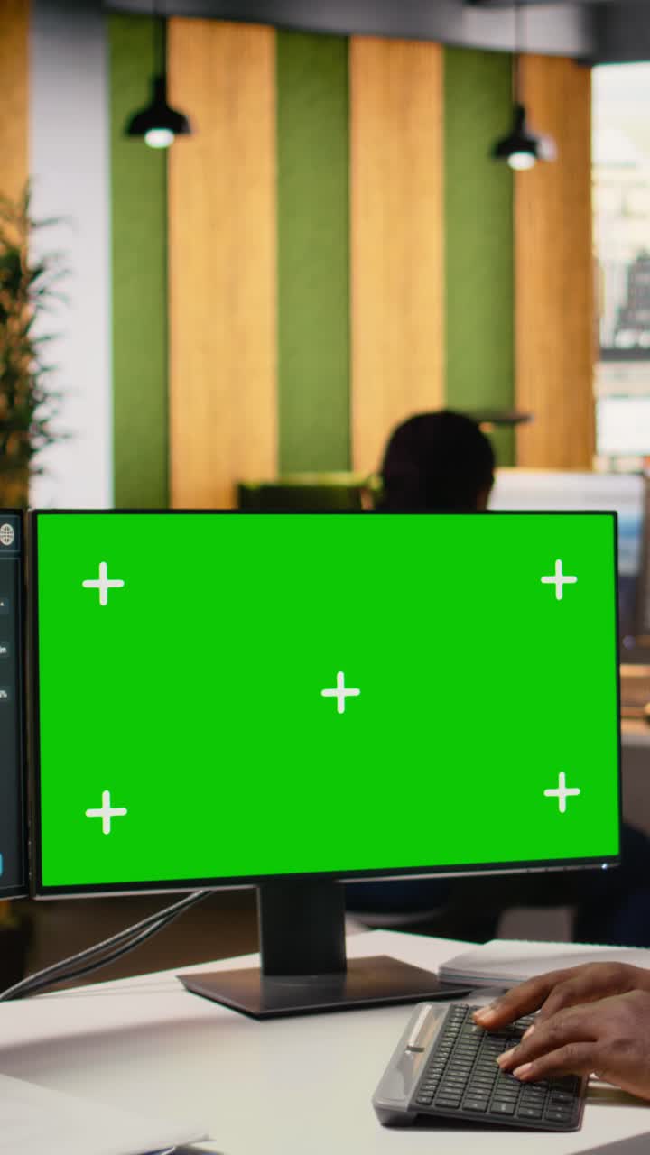 Engineer using green screen mockup PC to create advanced solar cell technology