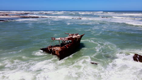 Rusted-and-weathered-shipwreck-of-Meisho-Maru-No-38-on-Agulhas-coastline,-aerial