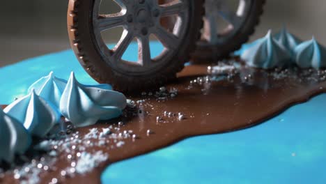 blue children's cake with car wheels