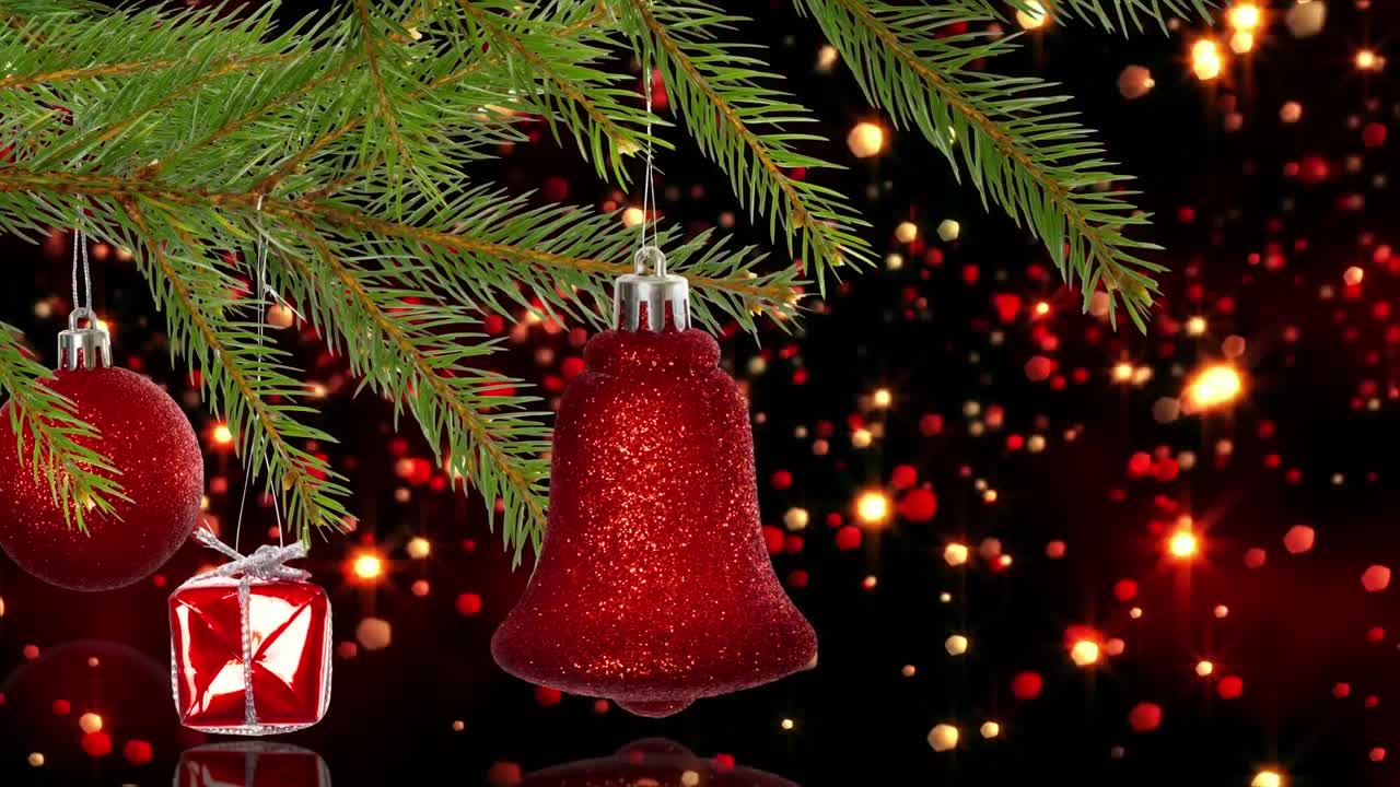animación de decoraciones navideñas sobre manchas brillantes en un fondo oscuro