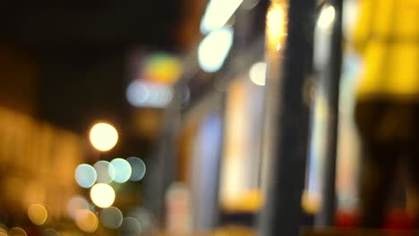 Man-walks-home-through-town-centre-traffic-at-night