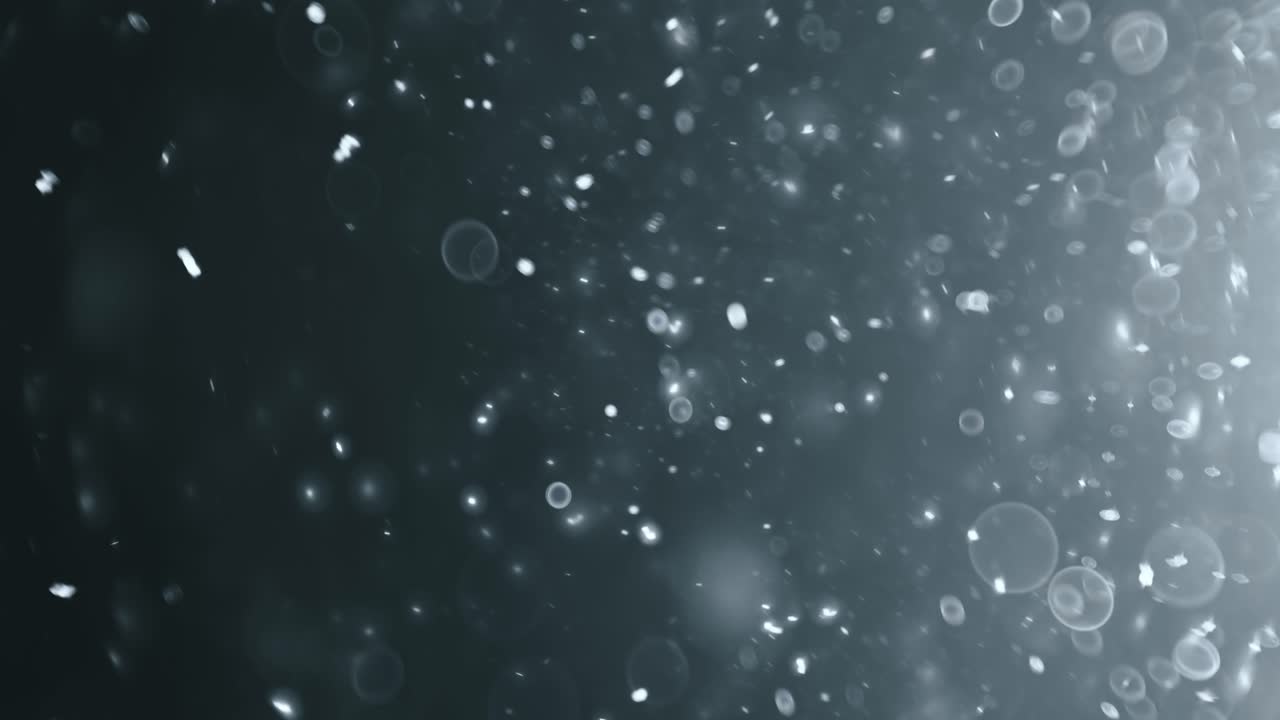 Floating abstract particle bokeh on dark background