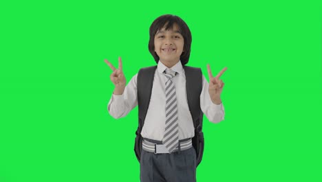 Happy-Indian-school-boy-showing-victory-sign-Green-screen