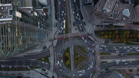 Aerial-birds-eye-overhead-top-down-panning-view-of-cars-stuck-in-traffic-jam.-Multilane-road-around-large-and-complex-intersection-in-city-centre.-Warsaw,-Poland